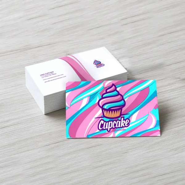 Stack of custom Cupcake Sweetcake business cards: pink and teal swirl front, white contact back with pink swoosh.