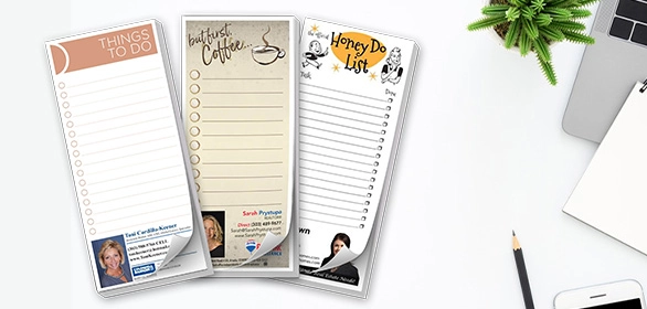 Three vertical to-do list notepads with coffee, honey-do, and task themes beside a pencil and plant.