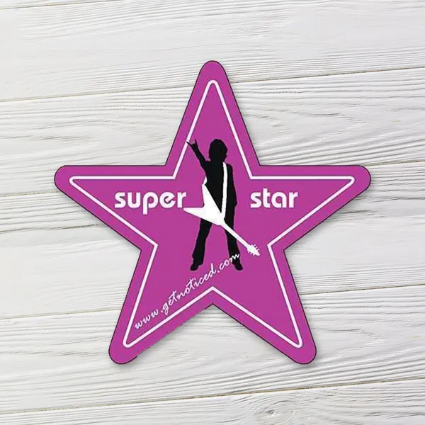 Purple star-shaped magnet 3.125" promotional product with silhouette design on white wood background.