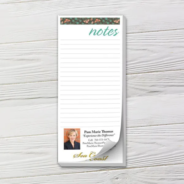 Custom notepad with floral header and lined pages on white wood background