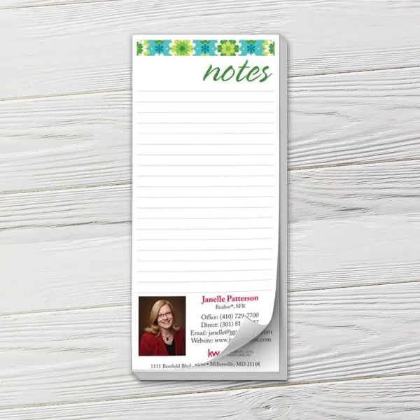 Custom notepad with blue and green floral header design, lined pages, and white background