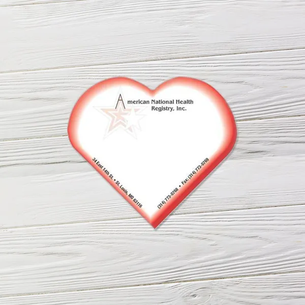 Red heart shaped promotional sticky notes with white center on wooden surface