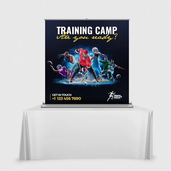 Black tabletop display banner with blue and red athletic imagery on white table stand