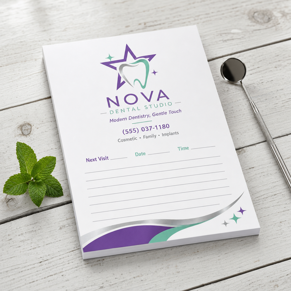 Custom 5.25 x 8.5 inch Nova Dental Studio notepad with star tooth logo, phone and Next Visit lines, by a dental mirror