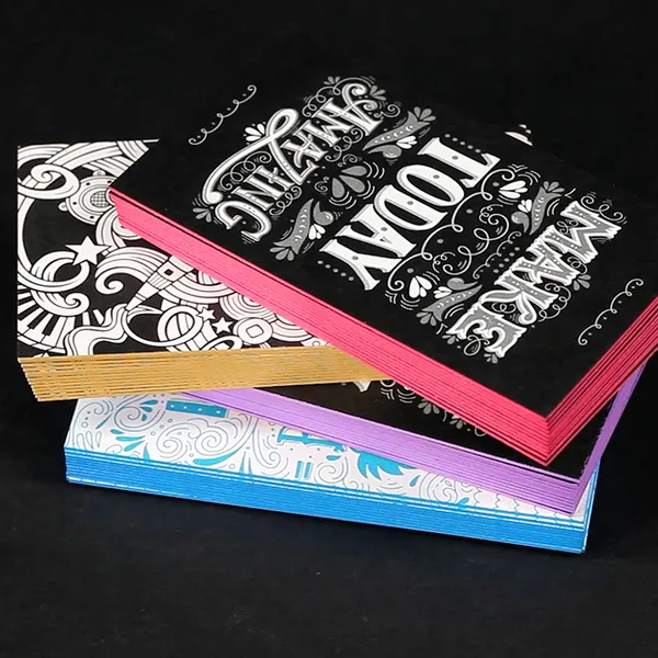 Painted Edge Business Cards with colorful edges and ornate white designs on black, custom notepad style