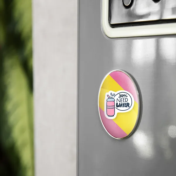 Oval magnet with pink and yellow color scheme, promotional product sample displayed on metal surface