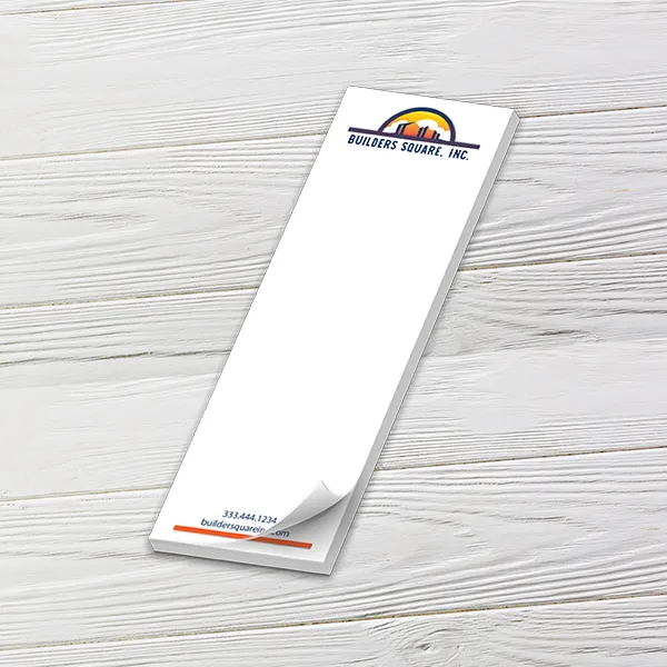 Custom 2 x 6 inch narrow notepad with a Builders Square logo and colored border, top sheet curling, on white wood