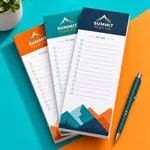 Custom 3.5 x 8 inch Summit Peak Co to-do checklist pads in orange, teal and navy with a pen