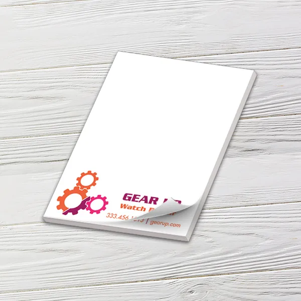 Custom 3 x 4 inch small memo pad with a watch repair gear logo on white wood
