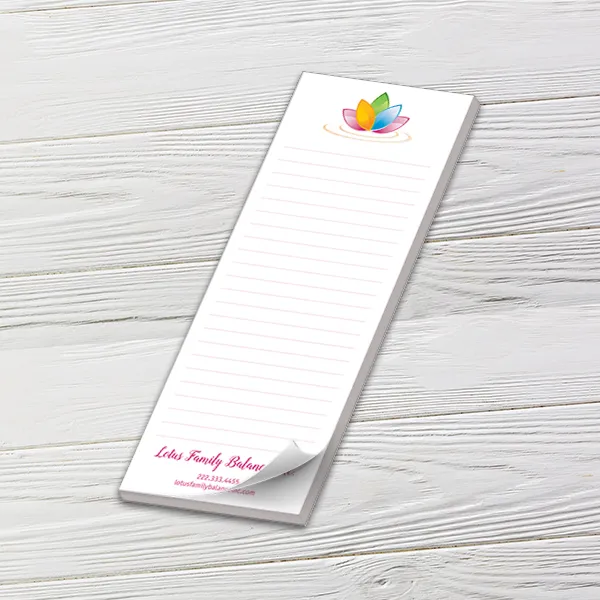 Custom 3 x 8 inch lined list pad with a lotus wellness logo, top sheet curling, on white wood