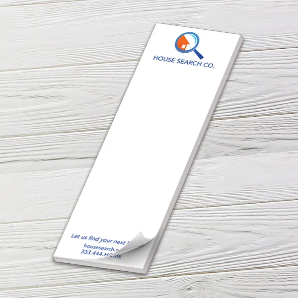 Custom 3 x 9 inch long notepad with a House Search Co. logo, top sheet curling, on white wood