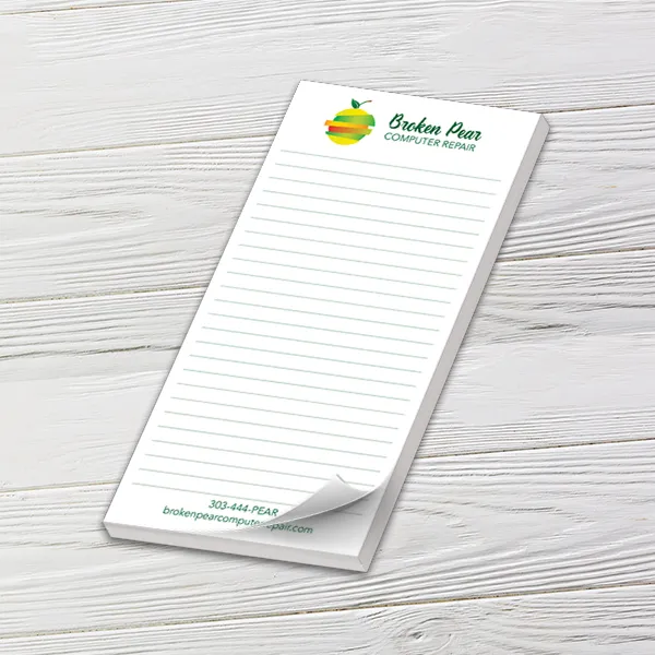 Custom 4 x 8 inch lined logo notepad for a computer repair business on white wood