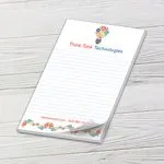 Custom 5.5 x 8.5 inch Think Tank Technologies lined notepad with a curled sheet on whitewashed wood