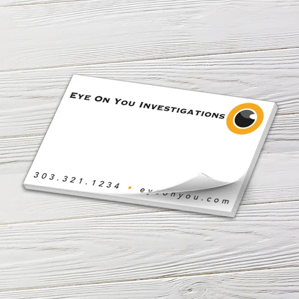 Custom 5 x 3 inch landscape tear-off pad with an investigations eye logo on white wood