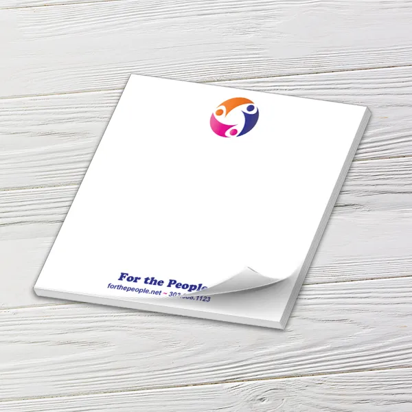 Custom 6 x 6 inch large square notepad with a colorful nonprofit logo and web address, on white wood