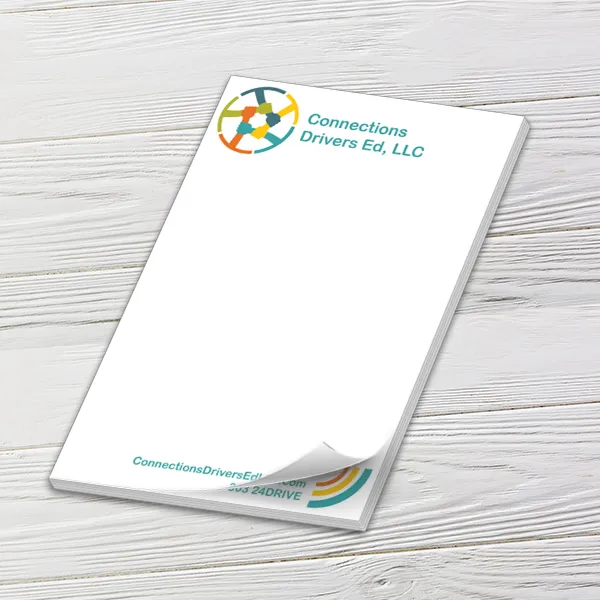 Custom 6 x 9 inch Connections Drivers Ed notepad with a curled top sheet on white wood boards