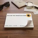 Custom 5 x 3 inch private investigator notepad, top sheet curling, on a desk with sunglasses and a magnifying glass