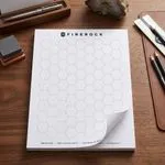 Custom 8.5 x 11 inch large hexagon grid notepad shown flat, printed with a large honeycomb pattern on a tear-off top-bound pad.