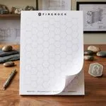 Custom 8.5 x 11 inch large hexagon grid notepad standing upright, with a large honeycomb pattern on a top-glued pad.