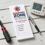 Custom 2 x 6 inch HVAC company list pad with logo, phone and service checkboxes, beside a thermostat and screwdriver