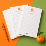Custom 6 x 9 inch TO DO checklist pads with an orange-slice logo on orange and green paper
